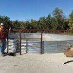 Dean Thomas standing next to the newly installed 11,500 gallon tank. Photo submitted
