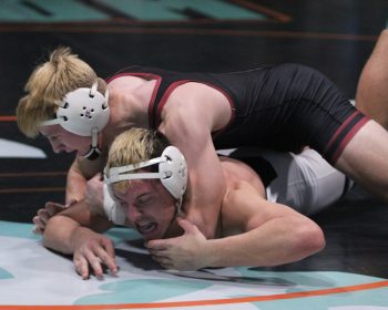 In a battle of ranked 172-pounders in the finals of the FCLMC wrestling tourney, Chatfield’s #7 Ben Carrier has top control of LFCMC’s #5 Kane Larson. Carrier built a 9-0 lead then held on for an 11-8 decision win to claim the title. Photo by Paul Trende