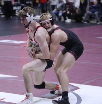 Chatfield’s Carson Rowland hangs on for control of Iowa-Grant/Highland’s Tyson Imhoff in the final seconds of their semifinal match at the Bi-State Tourney. In a battle of top-ranked kids, Rowland won a 5-2 decision, but then fell to another top-ranked wrestler, Danny Heiser of Evansville, in the finals, to finish as runner-up at 157. Photo by Paul Trende