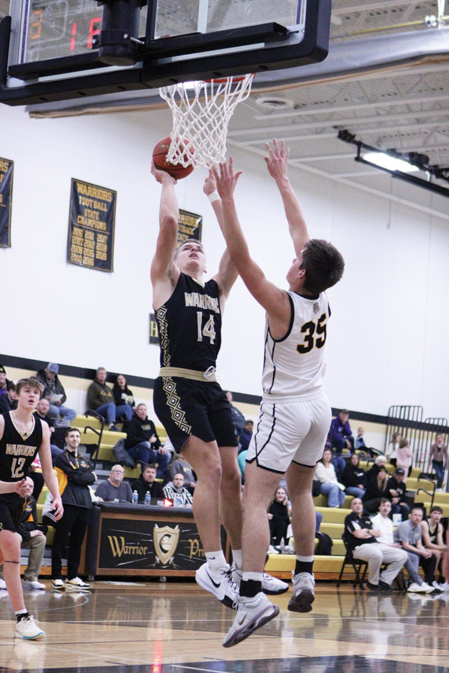 Caledonia’s Ethan Stendel rises for a shot over PEM’s Jack Schrieber in the teams’ TRC affair. The second-ranked Warriors kept up their winning ways, beating the Bulldogs and then Maranatha Academy to run their win streak to seven. Photo by Paul Trende