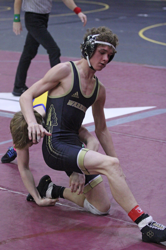 Caledonia/Houston’s Aiden Burns tries to free a leg in a consolation match during the Bi-State tourney. Burns was the sole Warrior to place at the event, as he took eighth (of 43) at 113-pounds. Photo by Paul Trende