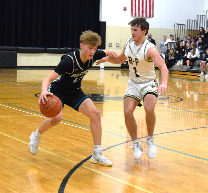 Rushford-Peterson’s Cole Thompson checks Fillmore Central’s Bridon Bahl in the teams’ TRC match-up. The Trojans’ bevy of active guards and forwards helped force 27 FC turnovers (versus 36 shots) in a controlling 53-41 win. R-P improved to 13-2. Photo by Deb Finseth