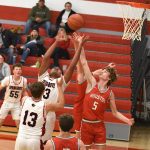 Devon Williams of Spring Grove and Carter Geiwitz (#5) of Houston vie for a rebound. Williams led Spring Grove’s scoring with 11 points while Geiwitz passed out a game-high seven assists, as Houston notched their first win over the Lions in eight tries, 56-40. Photo by Lee Epps