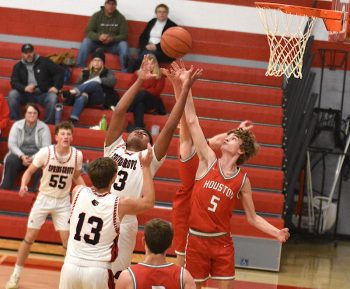 Devon Williams of Spring Grove and Carter Geiwitz (#5) of Houston vie for a rebound. Williams led Spring Grove’s scoring with 11 points while Geiwitz passed out a game-high seven assists, as Houston notched their first win over the Lions in eight tries, 56-40. Photo by Lee Epps