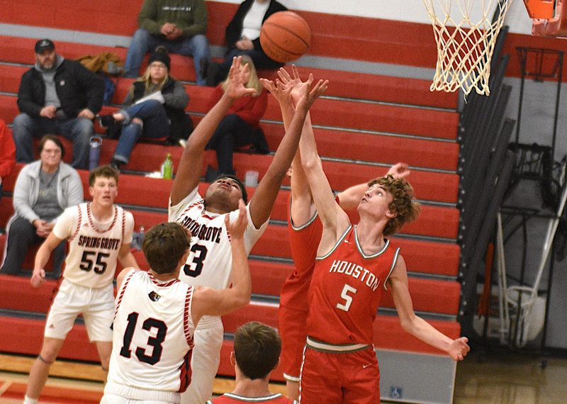 Devon Williams of Spring Grove and Carter Geiwitz (#5) of Houston vie for a rebound. Williams led Spring Grove’s scoring with 11 points while Geiwitz passed out a game-high seven assists, as Houston notched their first win over the Lions in eight tries, 56-40. Photo by Lee Epps