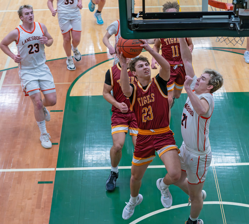 Rushford-Peterson’s Creighton Hoiness attacks the rack defended by Lanesboro’s David Harvey. The #7 in Class A Trojans posted wins over FC and the Burros at a home tourney to improve to 7-1 on the year. Photo by Dawn Hauge