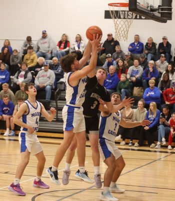 Kingsland’s Seth Howard looks to deny Mabel-Canton’s Darian Hershberger inside in the teams’ SEC matchup. The Knights led by double digits and withstood a late Cougar push to prevail 67-63. Photo by Christine Vreeman