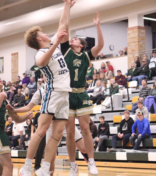 Fillmore Central’s Bridon Bahl and Rushford-Peterson’s Cole Thompson battle for a rebound at the Trojans’ holiday tourney. R-P whipped FC 86-39. Photo by Paul Trende