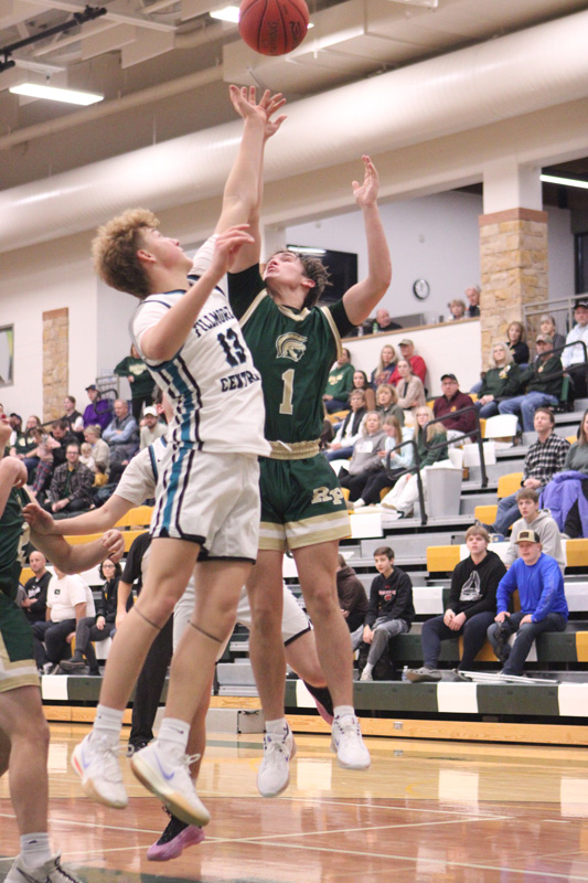 Fillmore Central’s Bridon Bahl and Rushford-Peterson’s Cole Thompson battle for a rebound at the Trojans’ holiday tourney. R-P whipped FC 86-39. Photo by Paul Trende