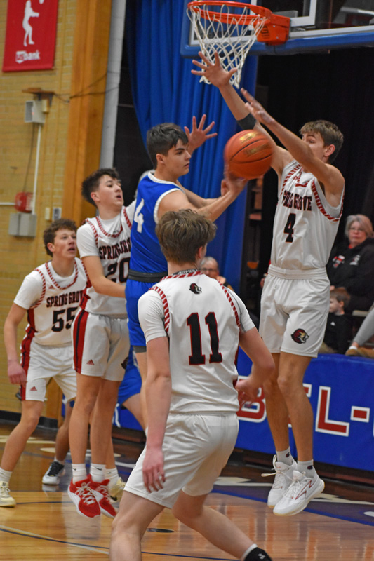 Mabel-Canton’s Isaac Underbakke looks for somewhere to go with the ball, as he is surrounded by Spring Grove’s Lyric Stadler (#20) and Ben Udstuen (#4). SG posted a 71-33 win in the game, winning the second half 37-10. Photo by Heather Kleiboer