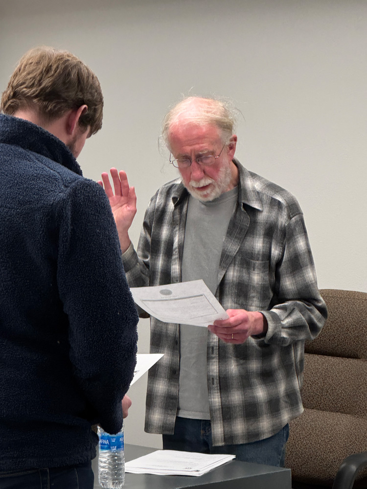 Caledonia City Clerk/Administrator Jake Dickson administers the Oath of Office to the newly elected council member, John Rauk, at the January 27 council meeting. Photo by Charlene Corson Selbee