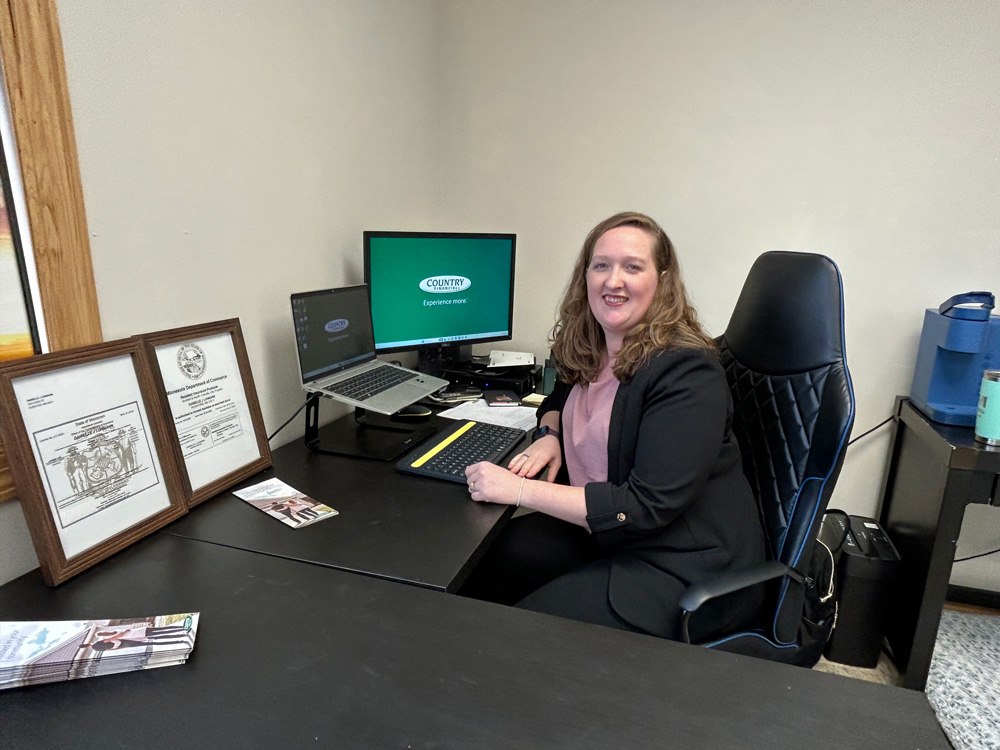 Danielle Luhmann at her desk in the Country Financial office in Rushford. Photo by Wanda Hanson