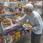 Volunteer Marlene Peterson stocks the shelves at the Preston Food Shelf. Photo by Hannah Wingert