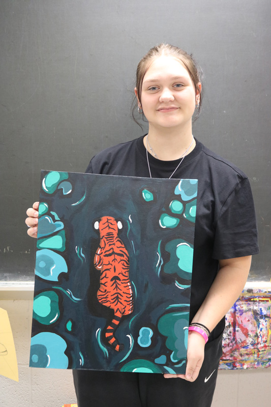 Kayleigh Wangen, senior at Lanesboro High School, with her acrylic painting of a tiger in a lagoon. Photo by Barb Jeffers