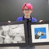 Riley Johnson, senior at Lanesboro High School, poses with her entries for the Juried High School Art Show at Lanesboro Arts. On the left is a still life drawing and on the right is a watercolor print of a puffin. Photo by Barb Jeffers