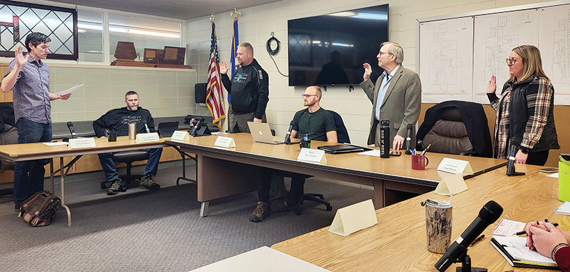 Harmony councilors Jesse Grabau, Steve Donney and Tara Morem are sworn in by Greg Schieber, far left. Also shown seated are Kyle Scheevel and Michael Himlie. Photo by Hannah Wingert