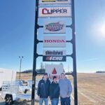 Celebrating 25 years of success, Harrington Enterprises owners Chad and Camri Harrington, along with their son Carter, stand proudly beneath their business sign – a symbol of their dedication to family, hard work and customer service. Photo submitted