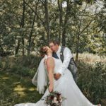 Jacob and Chelsey Hoscheit enjoying a kiss. Photo by Sydnie and Me Photography