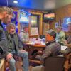 From left to right: Josh Norlien, Steve Westby, John Evenson, Derek Wallace, Margaret Knutson and Patrick Forsyth chat after the meeting. Norlien, Westby and Wallace discussed the possibilities of collaboration on the March 15 season opening day for Money Creek Outfitters and Owl City Cycles. Photo by Wanda Hanson