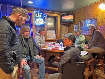 From left to right: Josh Norlien, Steve Westby, John Evenson, Derek Wallace, Margaret Knutson and Patrick Forsyth chat after the meeting. Norlien, Westby and Wallace discussed the possibilities of collaboration on the March 15 season opening day for Money Creek Outfitters and Owl City Cycles. Photo by Wanda Hanson