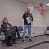 Left to right, Coach Carl Fruechte and Greg Hoscheit discussing the need for a new press box. Photo by Kaitlin Longhauser