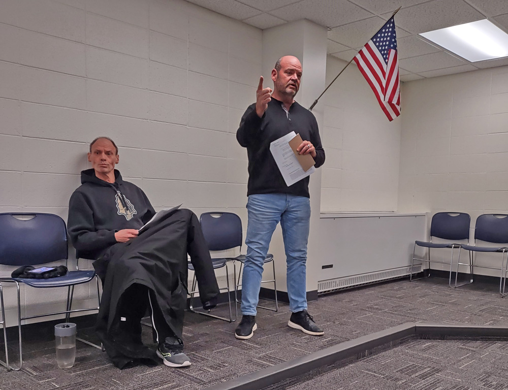 Left to right, Coach Carl Fruechte and Greg Hoscheit discussing the need for a new press box. Photo by Kaitlin Longhauser