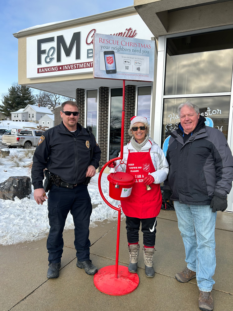 Police Chief Blaise Sass, Dawn Hellickson and Mayor Kurt Reicks taking time out of their busy day to help others in the community. Photo submitted