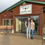 New owners, Ryan and Daisy Ruberg, pose in front of The Sawmill Inn in Houston. Photo by Wanda Hanson