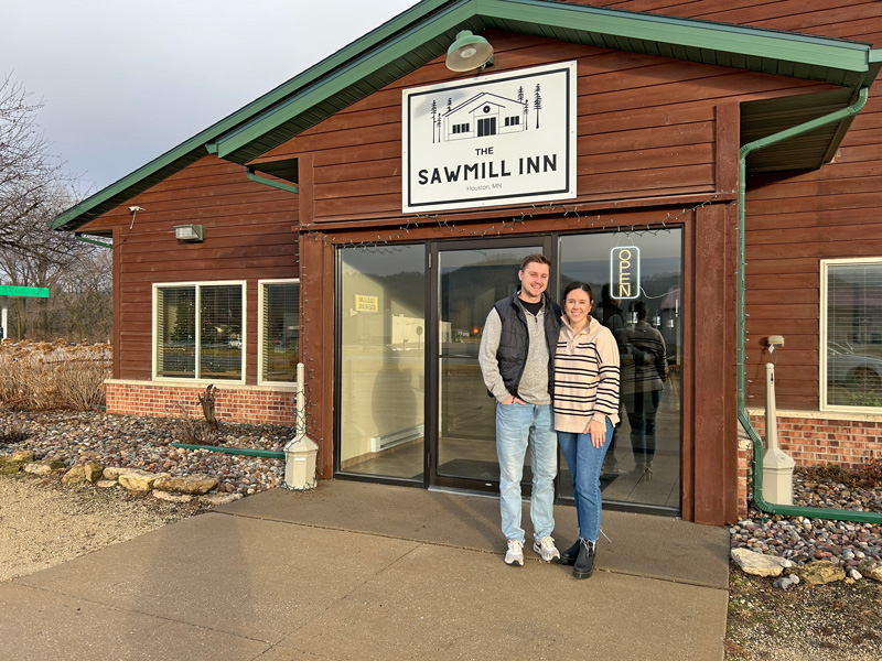 New owners, Ryan and Daisy Ruberg, pose in front of The Sawmill Inn in Houston. Photo by Wanda Hanson