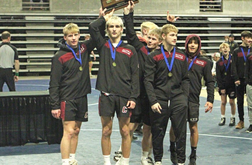 Five Chatfield seniors (left to right) Ben Carrier, Ayden Miner, Alden Pearson, Carson Rowland, and Javier Berg plus a mostly-occluded Wyatt Jacobson gather around the Section 1A team wrestling trophy. The Gophers dominatingly repeated as champs, beating three foes by a combined 192-23 score. Photo by Paul Trende