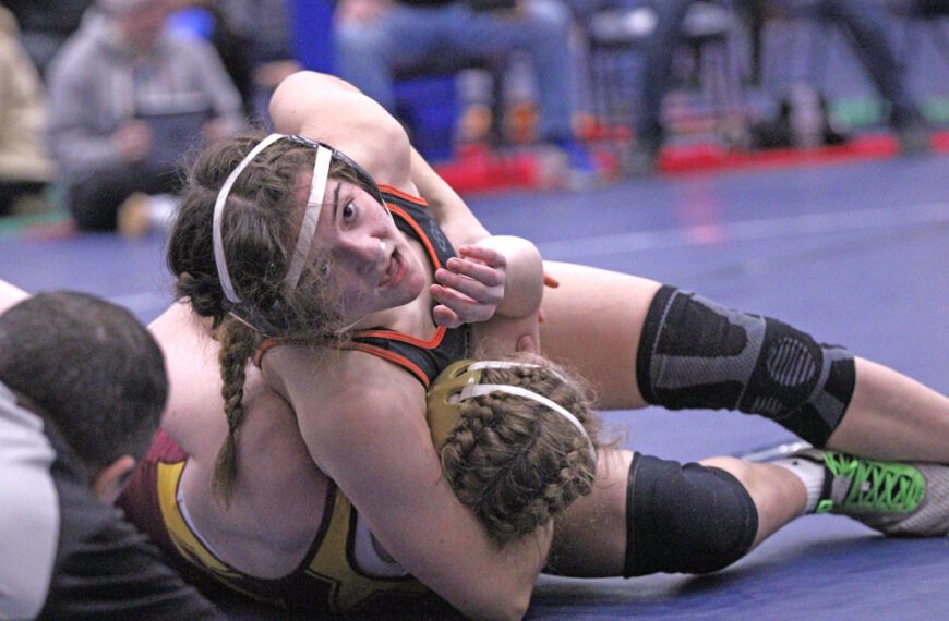 FCLMC 8th grader Charlotte Ferrie uses the headlock to pin Northfield’s #6 Lainey Houts, as #10 Ferrie trailed 6-0 in the match. Said win was huge in securing Ferrie a trip to state as the Section 1/2 runner-up at 130-pounds. Photo by Paul Trende