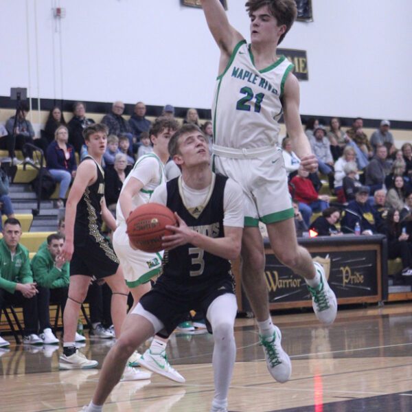 Caledonia’s Grant King gets Maple River’s Cole Davis up in the air in the teams’ Saturday contest. The #3 in Class AA Warriors won three non-conference games on the week, including the game above 88-57, running their win streak to eight straight. Mason King scored 38 points versus Maple River. Photo by Paul Trende