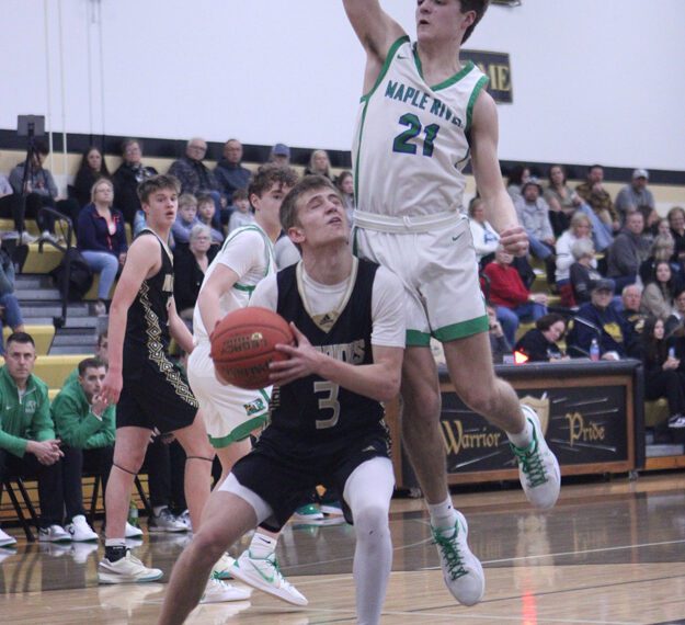 Caledonia’s Grant King gets Maple River’s Cole Davis up in the air in the teams’ Saturday contest. The #3 in Class AA Warriors won three non-conference games on the week, including the game above 88-57, running their win streak to eight straight. Mason King scored 38 points versus Maple River. Photo by Paul Trende