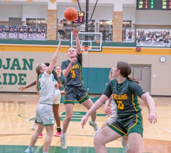 Rushford-Peterson’s Emily Helgemoe flips up the lane shot while teammate Kaia Loney is also pictured in the Trojans’ 73-34 opening round playoff win over Lyle/Pacelli. Photo by Dawn Hauge