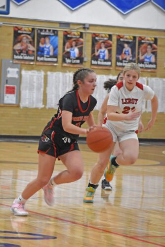 Spring Grove’s Siri Konkel pushes the ball offensively while LeRoy-Ostrander’s Allison Siskow chases. With Kinley Soiney breaking the Mabel-Canton all-time girls scoring mark, SG topped L-O 65-25. The 19-5 Lions are Section 1A’s two-seed. Photo by Heather Kleiboer