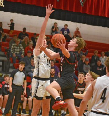 Spring Grove’s Kolton Nerstad tests the length of Kingsland’s Max Erdman in the teams’ SEC battle. The Lion boys (8-11) beat two above-five-hundred squads on the week, the Knights (11-8) by 63-60 final, and Blooming Prairie (13-5) by 60-41 final. Photo by Lee Epps