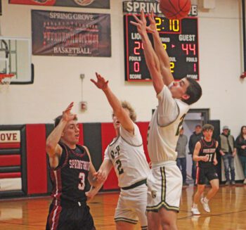 Spring Grove’s Troy Reinhardt just gets the pass over the double team of Rushford-Peterson’s Jaxson Meldahl (#2) and Landon Dahl. In the teams’ non-conference rivalry match-up, R-P posted a controlling 66-34 win. Photo by Paul Trende