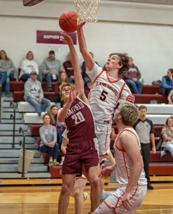 Chatfield’s Ross Stoehr encounters the length of Lanesboro’s Nick Taylor in the teams’ non-conference matchup. But the Gophers made 25 of 26 free throws (96%) in the contest, tying the 10th best mark in state history, in a 69-33 win. Photo by Leif Erickson