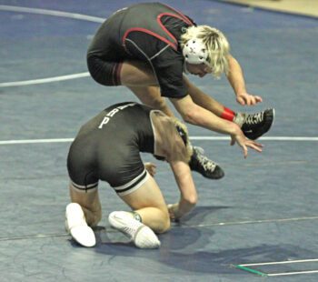 Chatfield’s Ayden Miner gets takedown points the Saquon Barkley way, leaping backwards over LARP’s Nolan Happel to secure control. Miner posted a 15-0 tech fall win, his 101st career victory. He grabbed win number 100 in the team quarterfinals versus Triton. Photo by Paul Trende