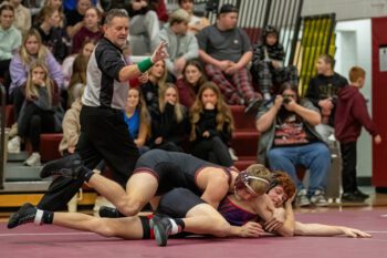 Chatfield’s Carson Rowland works over GMLOS’ Calum Sween at the Gophers’ triangular that also included PEM. Rowland posted his 175th win at the event, as Chatfield swept both duals to complete a TRC sweep, and grab the conference wrestling title. Photo by Leif Erickson