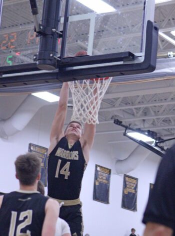 Caledonia’s Ethan Stendel slams down one of his five dunks in the #3 Warriors dominating 82-48 win over #9 in AA Cannon Falls. The Warriors have won 12 straight and they are 23-2 overall. Photo by Paul Trende