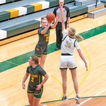 Rushford-Peterson’s Nevaeh Happel shoots over the long arm of 6’0” Sienna Augedahl of Caledonia in the teams’ TRC matchup. The #6 in Class AA Warriors posted a 70-39 win to secure the outright TRC-East title and get to 20 wins (20-3). Photo by Dawn Hauge