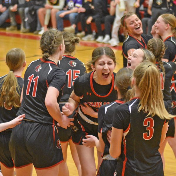 Spring Grove/Mabel-Canton’s girls celebrate at 60-45 win over Southland in their regular season finale, which clinched the Lions there second straight SEC crown (a share with Grand Meadow). Coach Taylor Elton’s Lions (21-5) are 1A’s 2-seed. Photo by Lee Epps