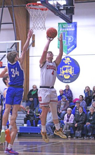 LeRoy-Ostrander’s Ryder Stern gets a free look at the layup as Mabel-Canton’s Kale Eiken tries to defend. The Cardinals won their fourth in a row, beating the Cougars 74-55, as Camden Hungerholt became the boys all-time leading scorer. Photo by Paul Trende
