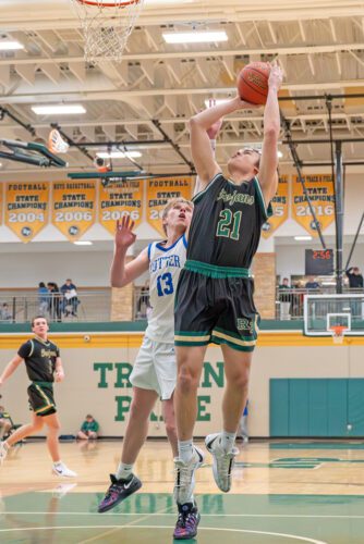 Rushford-Peterson senior Caden Johnson gets free for a layup in the Trojans’ regular season finale 70-53 win over Cotter. R-P won its sixth straight game, and they improved 21-4, and Johnson is the only senior. Photo by Dawn Hauge