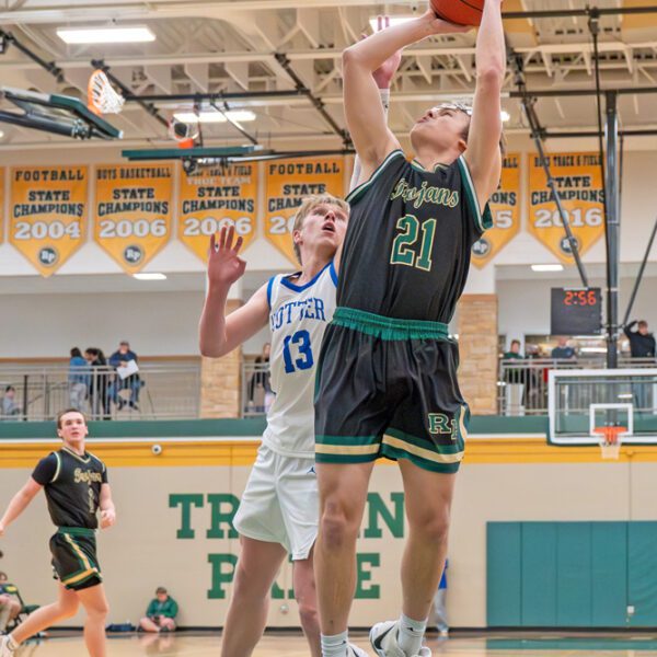 Rushford-Peterson senior Caden Johnson gets free for a layup in the Trojans’ regular season finale 70-53 win over Cotter. R-P won its sixth straight game, and they improved 21-4, and Johnson is the only senior. Photo by Dawn Hauge