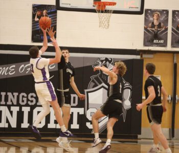 Grand Meadow’s Cohen Craft shoots a fadeaway over Kingsland’s Gavin Hubka in the teams’ SEC matchup. The Larks (2-13) pulled maybe the SEC’s biggest league upset of the year, topping the Knights (11-6) by a 66-62 final. Photo by Christine Vreeman