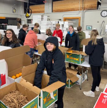 Packing fruit for the annual fruit sale. Photo submitted
