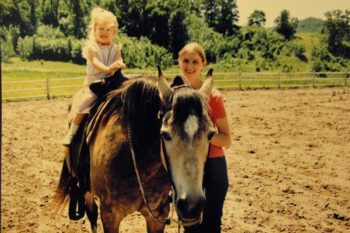 Julia (age two at the time) with her mom Beth and her horse Queenie. Photo submitted