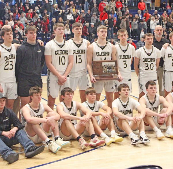 A relatively somber bunch of Caledonia Warriors poses with their state Class AA Fourth Place trophy. Team Cal went 1-2 at state, but in each of their losses, they resiliently came back to tie after trailing by 20-plus points. The Warriors finish an excellent year with a 29-4 record. Photo by Paul Trende